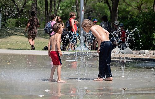 Mike Thiessen / Winnipeg Free Press 
Siblings Orion (left) and Ronan Trudeau beat the heat at the Fort Parka splash pad at The Forks. 230620 &#x2013; Tuesday, June 20, 2023