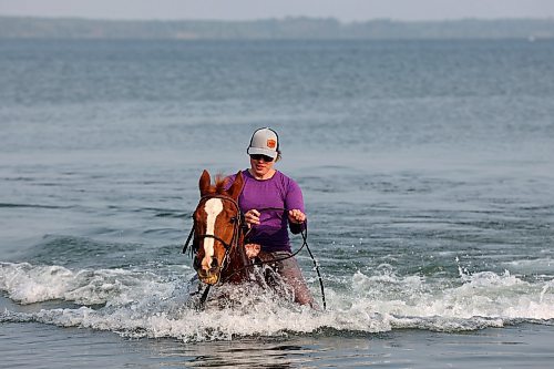 15062023
Molly Kelleher, manager of Elkhorn Riding Adventures, swims with her quarter horse Ice in Clear Lake in Riding Mountain National Park on an early morning last week. Ice, a sixteen-year-old barrel racing horse, tore a tendon in his front right leg last summer and has been rehabilitating for the past year. According to Kelleher, swimming has played an important part in Ice&#x2019;s rehab which has also included stem cell therapy and shockwave therapy. 
(Tim Smith/The Brandon Sun)
