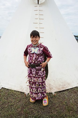 Willow Bogacki, age 9, wore a traditional jingle dress and moccasins to the pow wow held at Rolling River First Nation on Wednesday. (Miranda Leybourne/The Brandon Sun)