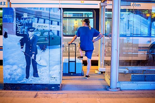 Mike Sudoma/Winnipeg Free Press
A pedestrian stands waiting for a bus along Portage Avenue around 1140pm Tuesday evening 
June 20, 2023