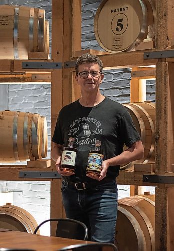Mike Thiessen / Winnipeg Free Press 
Patent 5 Distillery owner and co-founder Brock Coutts in the barrel room with the distillery&#x2019;s two upcoming releases, a whisky and an aged rum. Patent 5 will likely be releasing the whisky in time for this weekend&#x2019;s Uncorked event. For Ben Sigurdson. Wednesday, June 21, 2023