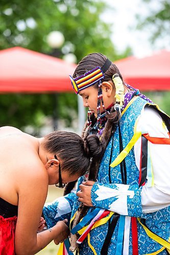 MIKAELA MACKENZIE / WINNIPEG FREE PRESS


Jessica Bird helps her son, Harley (12), get his men&#x573; traditional regalia on for the Pow Wow on National Indigenous Peoples Day at The Forks on Wednesday, June 21, 2023.  For Cierra Bettens story.
Winnipeg Free Press 2023