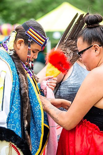 MIKAELA MACKENZIE / WINNIPEG FREE PRESS


Jessica Bird helps her son, Harley (12), get his men&#x573; traditional regalia on for the Pow Wow on National Indigenous Peoples Day at The Forks on Wednesday, June 21, 2023.  For Cierra Bettens story.
Winnipeg Free Press 2023