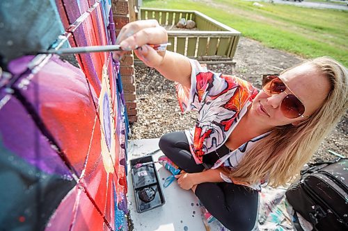 Mike Deal / Winnipeg Free Press
Rachel Lancaster works on a mural on the side of WinRose Animal Hospital on St. Anne's at Bishop Grandin Boulevard, Monday morning.
Rachel Lancaster, a mural artist who, for about 10 years now, has been transforming bedroom walls, garage doors and sides of businesses into works of art. No project is too big or too small - and what she comes up with is up to the imagination of those hiring her to do their bidding.
230619 - Monday, June 19, 2023.