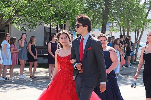 Gabrielle Hunter-Rank and Adam Gabrielle walk down 2nd Avenue in Rivers during Rivers Collegiate’s 2023 graduation parade. (Kyle Darbyson/The Brandon Sun)