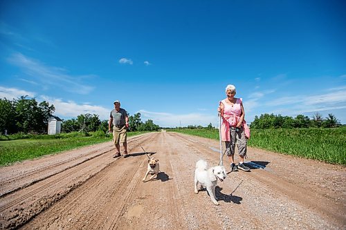 MIKAELA MACKENZIE / WINNIPEG FREE PRESS


Michael Martin and his sister, Evelyn Doerksen, walk their dogs Maddy and Coral near Elma, Manitoba on Thursday, June 22, 2023.  For Eva Wasney story.
Winnipeg Free Press 2023