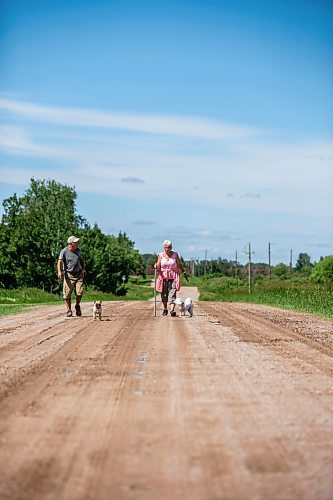 MIKAELA MACKENZIE / WINNIPEG FREE PRESS


Michael Martin and his sister, Evelyn Doerksen, walk their dogs Maddy and Coral near Elma, Manitoba on Thursday, June 22, 2023.  For Eva Wasney story.
Winnipeg Free Press 2023