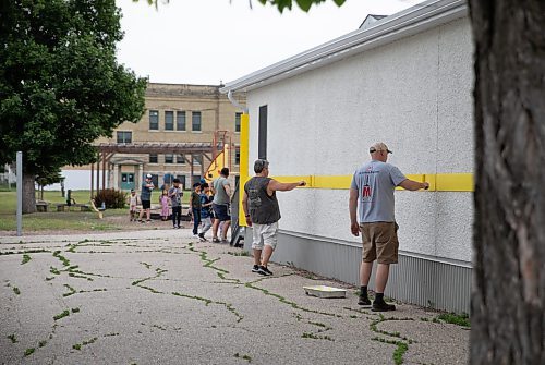 JESSICA LEE / WINNIPEG FREE PRESS

Workers paint over a portion of Keewatin Prairie Community School which was tagged with hate messages June 23, 2023.

Reporter: Malak