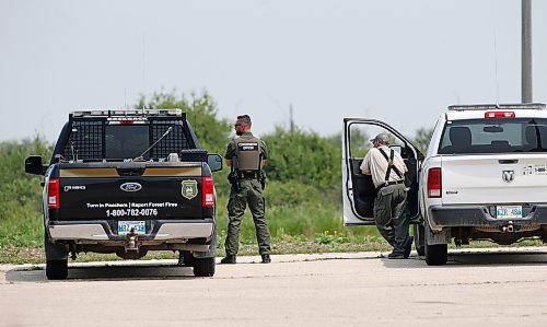 JOHN WOODS / WINNIPEG FREE PRESS
Conservation officers watch over a stand of trees for a coyote that mauled a small boy on Knowles Ave in Winnipeg&#x2019;s Springfield North area, Sunday, June 25, 2023. 

Reporter: May