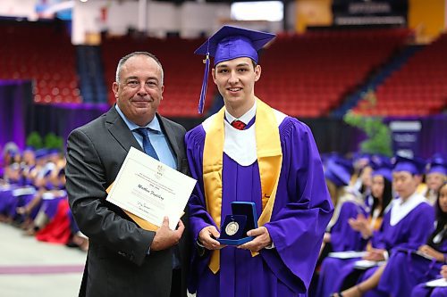 Vincent Massey High School principal Bryce Ridgen hands Matthew Fugleberg the Governor General’s Academic Medal during Monday’s graduation ceremony at the Keystone Centre. This award is reserved for students who have achieved the highest academic average at their respective school. (Kyle Darbyson/The Brandon Sun)