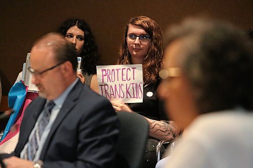 A Brandon School Division board meeting attendee holds up a sign that states "Protect Trans Kids" on Monday evening.  Local members of the LGBTQ+ community have rallied over the last couple weeks to ensure that the division does not institute a book review committee, given that the original person who suggested this initiative predominantly flagged material featuring gender diverse people as being inappropriate for children. (Kyle Darbyson/The Brandon Sun)