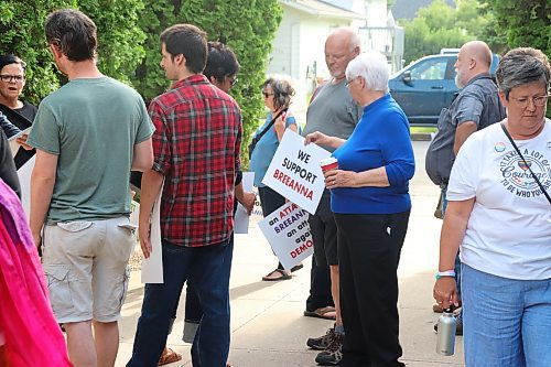 Supporters of Brandon School Division trustee Breeanna Sieklicki wait outside BSD headquarters for Monday's board meeting to begin. An attendee wearing a LGBTQ+ themed shirt can also be seen also waiting outside. (Kyle Darbyson/The Brandon Sun)