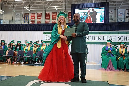 27062023
&#xc9;cole Secondaire Neelin High School principal Bas Nundu presents graduate Ashley Albert with her diploma during the high school&#x2019;s graduation and convocation ceremonies at the Brandon University Healthy Living Centre on Tuesday. (Tim Smith/The Brandon Sun)