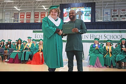 27062023
&#xc9;cole Secondaire Neelin High School principal Bas Nundu presents graduate Kelton Berry with his diploma during the high school&#x2019;s graduation and convocation ceremonies at the Brandon University Healthy Living Centre on Tuesday. (Tim Smith/The Brandon Sun)