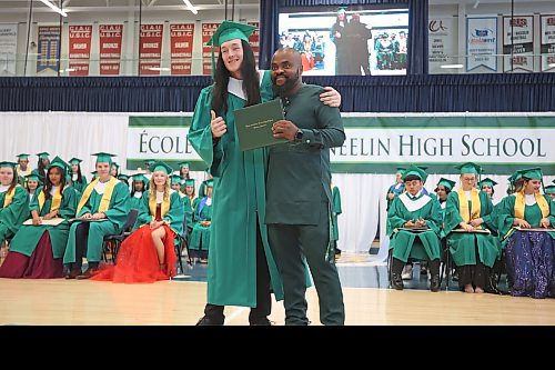 27062023
&#xc9;cole Secondaire Neelin High School graduate Paco Chambers embraces Neelin principal Bas Nundu while receiving his diploma during the high school&#x2019;s graduation and convocation ceremonies at the Brandon University Healthy Living Centre on Tuesday. (Tim Smith/The Brandon Sun)