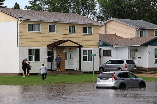 27062023
A car sits in a flooded street on Regent Crescent at East Fotheringham Drive in Brandon after heavy rains pounded Brandon on Tuesday leading to flooding throughout the city.
(Tim Smith/The Brandon Sun)