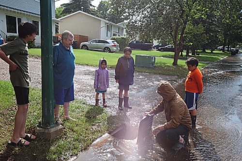 27062023
Residents opened drains to help relieve flooding on streets in Brandon's west end after heavy rains pounded Brandon on Tuesday leading to flooding throughout the city.
(Tim Smith/The Brandon Sun)