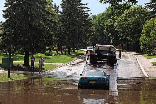 27062023
A car that stalled in flood water is loaded onto a tow truck on Darrach Bay after heavy rains pounded Brandon on Tuesday leading to flooding throughout the city.
(Tim Smith/The Brandon Sun)