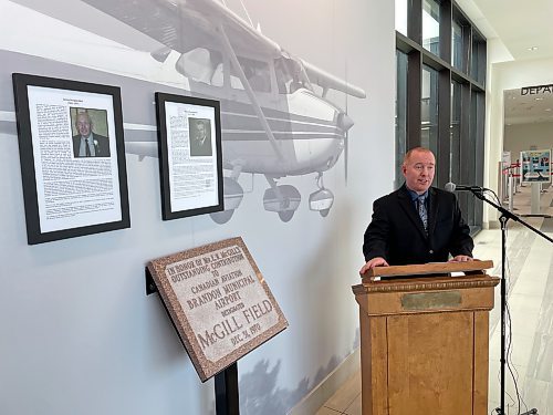 Brandon Municipal Airport manager Greg Brown officially inducts Ed McGill and Jim Wall into the facility's new wall of fame honouring local aviation pioneers on Wednesday. (Colin Slark/The Brandon Sun)