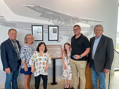 Family members of Ed McGill smile with pride after the former provincial cabinet minister and airport manager was inducted into the Brandon Municipal Airport Wall of Fame on Wednesday. HIs colleague Jim Wall was also inducted during the ceremony. (Colin Slark/The Brandon Sun)