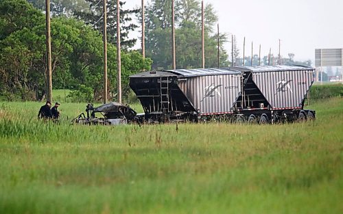 Police inspect the burned out cab of a semi truck on Tuesday evening that was involved in a collision with another vehicle on Highway 10 between the Brandon Municipal Airport and the community of Forrest. The collision had occurred earlier Tuesday afternoon. (Matt Goerzen/The Brandon Sun)