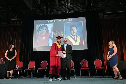 28062023
Nelson Flores Aguilar receives his diploma from principal Chad Cobb during Crocus Plains Regional Secondary School&#x2019;s class of 2023 graduation and convocation ceremonies at Westoba Place on Wednesday afternoon. (Tim Smith/The Brandon Sun)