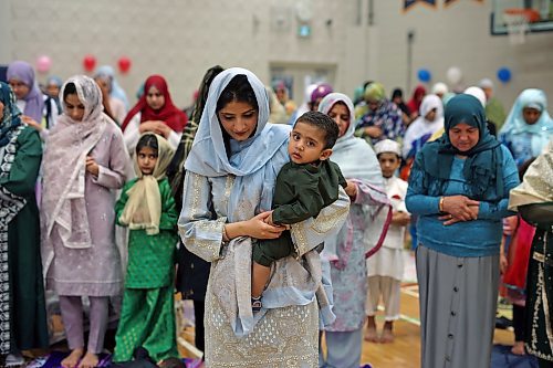 28062023
Rabia Malik, originally from Pakistan, holds her son Azlaan Awan during prayers with members of southwestern Manitoba&#x2019;s Muslim community gather at the Brandon University Healthy Living Centre on Wednesday in honour of Eid al-Adha - the feast of the sacrifice.  (Tim Smith/The Brandon Sun)