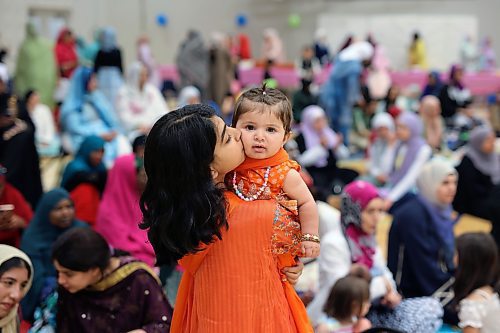 28062023
Ayesha Akram kisses her younger sister Abeera during Eid al-Adha celebrations with members of southwestern Manitoba&#x2019;s Muslim community at the Brandon University Healthy Living Centre on Wednesday.  (Tim Smith/The Brandon Sun)