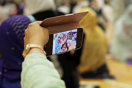 28062023
Ginnut Gafrin takes a selfie with children during the Eid al-Adha celebration with fellow members of southwestern Manitoba&#x2019;s Muslim community at the Brandon University Healthy Living Centre.  (Tim Smith/The Brandon Sun)