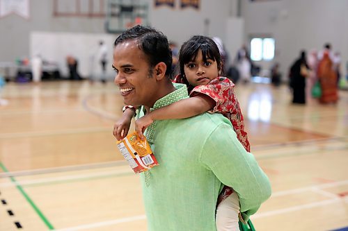 28062023
Moshiur Rahman carries his daughter Aleena on his back during Eid al-Adha celebrations with other members of southwestern Manitoba&#x2019;s Muslim community at the Brandon University Healthy Living Centre on Wednesday.  (Tim Smith/The Brandon Sun) 