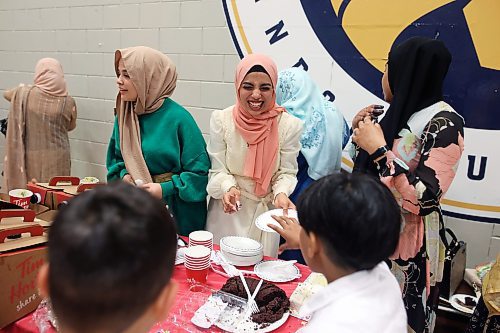 28062023
Kaltoum Alabeid smiles while serving cake during Eid al-Adha celebrations with other members of southwestern Manitoba&#x2019;s Muslim community at the Brandon University Healthy Living Centre on Wednesday.  (Tim Smith/The Brandon Sun) 