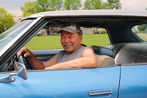 Norm Popien is all smiles as he sits behind the wheel of his 1973 Pontiac Parisienne Brougham four-door hardtop in Brandon on Wednesday. (Michele McDougall/The Brandon Sun).
