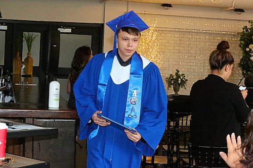 Prairie Hope High School graduate Connor Pace picks up his diploma at The Firehall event venue during the morning portion of Thursday’s graduation ceremony in downtown Brandon. (Kyle Darbyson/The Brandon Sun)  