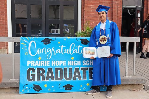 Devon Debruyne poses for a photo with his diploma outside The Firehall event venue following Thursday morning’s graduation ceremony in downtown Brandon. (Kyle Darbyson/The Brandon Sun)
