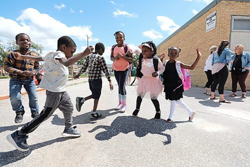 RUTH BONNEVILLE / WINNIPEG FREE PRESS

Local - School's Out!

Nigerian children from grades kindergarten to grade 2 at St. George School, do a little dance outside their school as they celebrate their last day of school and summer break on Thursday.  

Names Starting from the left
Feranmi  Akinroliev (boy with long sleeved shirt and jeans),
Oladayo olajuwon (boy with short sleeved shirt),
Oladeji Olajuwon  (boy with shorts),
Jasmine Osagie  (tall girl),
Victoria  Akinrolie (the girl with a pink skirt) and
Tamma Osagie ( girl with black dress)


Subject: Students/parents celebrating the end of the 2021-22 year at St. George School in the Louis Riel School Division.&#x200b;

SCHOOL WRAP: For the first time in three years, students and teachers are bidding farewell to their 2021-22 classrooms with traditional goodbyes &#x2014; field days and family barbecues among them. Teachers are reporting extra exhaustion this year, given students haven&#x2019;t had to have the stamina to study in-person in both May and June since late 2019. Stopping by a school this afternoon to take some shots of happy kids who are excited for the summer.

Reporter info: Maggie Macintosh  

July 30th, 2022