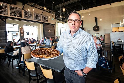 MIKAELA MACKENZIE / WINNIPEG FREE PRESS


Terry Friesen, general manager, holds a Giant Apple Pancake at the Original Pancake House on McGillivray on Thursday, June 29, 2023.   For Dave Sanderson story.
Winnipeg Free Press 2023