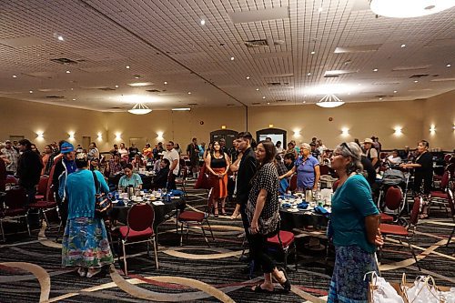Parents, grandparents, family and community members from Rolling River First Nation stand to honour the community's graduates of 2023 at the Victoria Inn in Brandon on Friday, June 30. (Miranda Leybourne/The Brandon Sun)