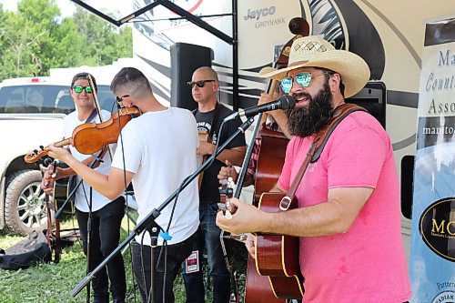 Quinton Blair, far right, performs alongside members of his band at the Dauphin's Countryfest campgrounds on Friday morning. Blair told the Sun afterwards that Friday marks the first time he's played at Countryfest since the COVID-19 emerged. (Kyle Darbyson/The Brandon Sun)