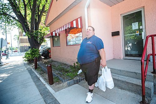 MIKAELA MACKENZIE / WINNIPEG FREE PRESS

Mark Segal picks up a takeout order at Mitzi&#x573; Chicken Finger Restaurant, which is up for sale (just after celebrating its 45th anniversary), downtown on Friday, June 30, 2023. For Gabby Piche story.
Winnipeg Free Press 2023.