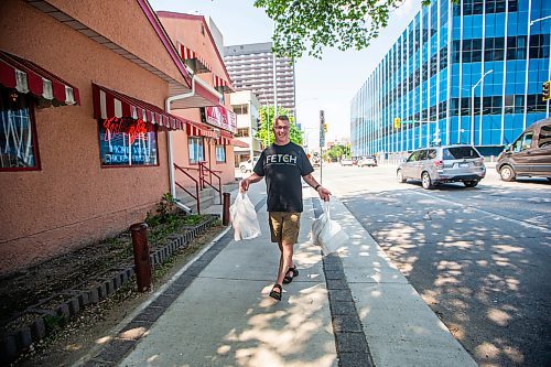 MIKAELA MACKENZIE / WINNIPEG FREE PRESS

Rick Yates picks up a takeout order at Mitzi&#x573; Chicken Finger Restaurant, which is up for sale (just after celebrating its 45th anniversary), downtown on Friday, June 30, 2023. For Gabby Piche story.
Winnipeg Free Press 2023.