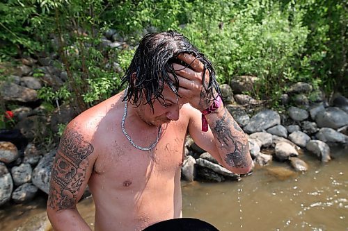 30062023
Maddy Bodz wipes water from his face after jumping into the creek near the campground at Dauphin&#x2019;s Countryfest 2023 on a hot Friday afternoon.
(Tim Smith/The Brandon Sun)