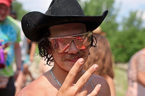 30062023
Water clings to Maddy Bodz&#x2019; sunglasses as he enjoys the creek near the campground at Dauphin&#x2019;s Countryfest 2023 on a hot Friday afternoon.
(Tim Smith/The Brandon Sun)