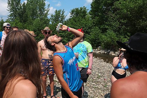 30062023
Festival-goers party at the creek near the campground at Dauphin&#x2019;s Countryfest 2023 on a hot Friday afternoon.
(Tim Smith/The Brandon Sun)