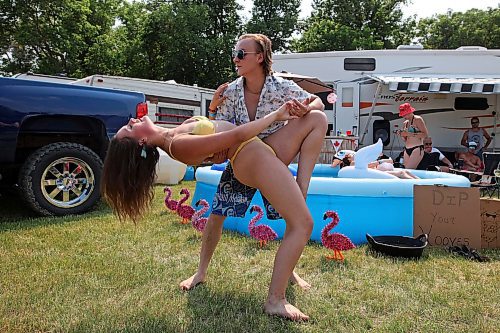30062023
Halle Dupre and Bryce Dubek dance at their campsite at Dauphin&#x2019;s Countryfest 2023 on a hot Friday afternoon.
(Tim Smith/The Brandon Sun)