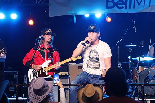 JR Charron performs on stage alongside guitarist Max Dupas, AKA Hamburger Island, during the first full day of Dauphin's Countryfest 2023. Friday marked Charron's official Countryfest debut. (Kyle Darbyson/The Brandon Sun)