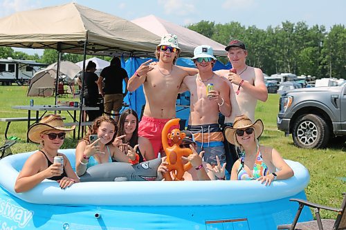 Some Dauphin’s Countryfest attendees cool off in an inflatable pool during a hot Friday afternoon, roughly an hour-and-a-half before the festival’s musical entertainment was scheduled to begin for the day. (Kyle Darbyson/The Brandon Sun)