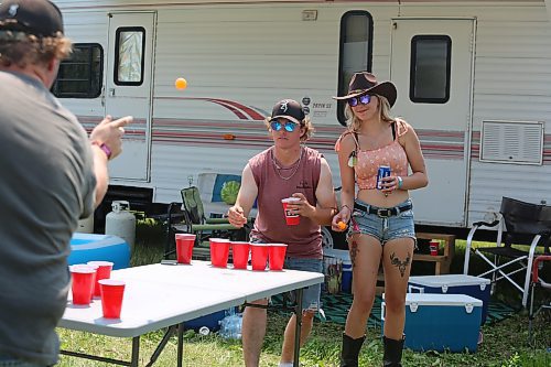 Some Dauphin’s Countryfest attendees play a game of beer pong early Friday afternoon, roughly an hour  before the festival’s musical entertainment was scheduled to begin for the day. (Kyle Darbyson/The Brandon Sun)
