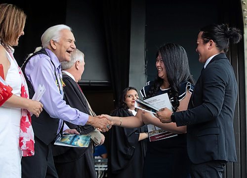 JESSICA LEE / WINNIPEG FREE PRESS

New Canadian citizens Angelica Revina and Victor Revina from the Philippines shake Elder Dr. Winston Wuttunee&#x2019;s hand at a citizenship ceremony July 1, 2023 at Assiniboine Park.

Reporter: Cierra Bettens
