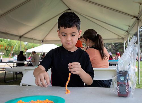 JESSICA LEE / WINNIPEG FREE PRESS

Bardia Rajabi, 6, is photographed at The Forks July 1, 2023, making an orange bracelet, signifying the Indigenous children who didn&#x2019;t survive residential schools.

Reporter: Cierra Bettens/stand up