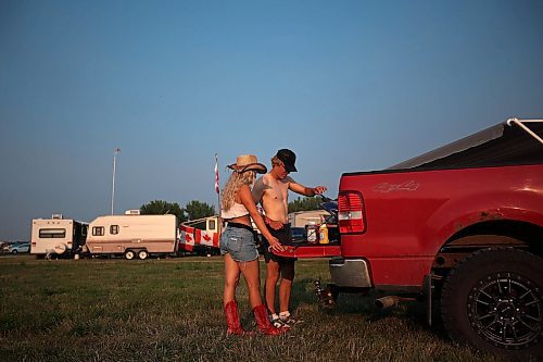 30062023
Payton Daciuk and Jackson Aldcroft cook hotdogs and burgers at their campsite during Dauphin&#x2019;s Countryfest 2023 on Friday evening.
(Tim Smith/The Brandon Sun)
